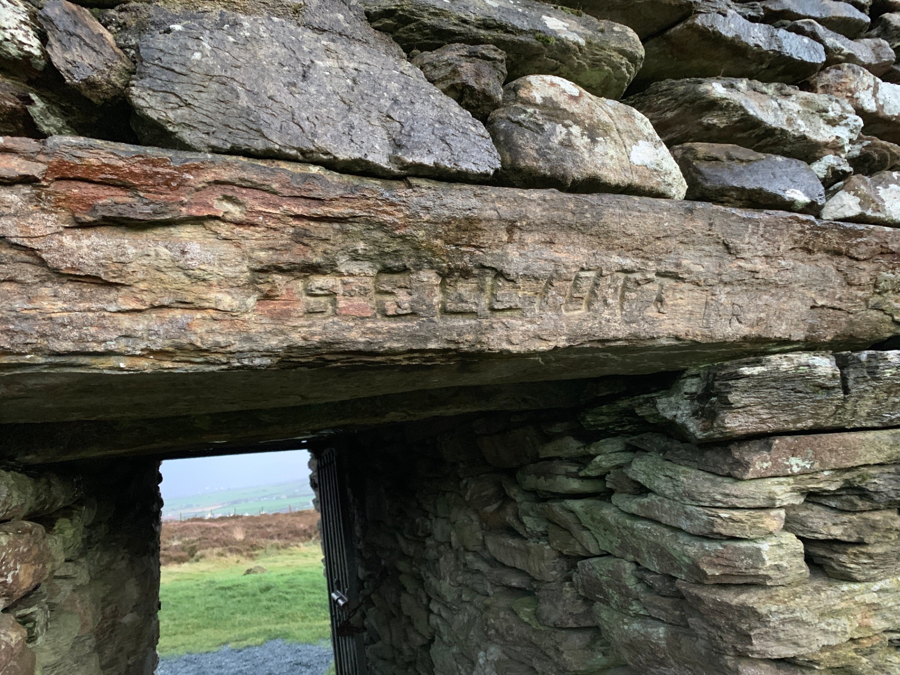 Carved inscription on the wooden lintel above the entrance to Grianán of Aileach